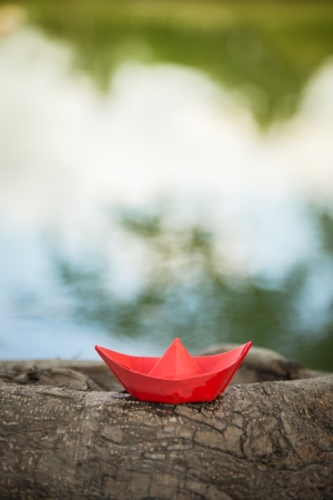 Red paper boat or Origami with natureの写真素材