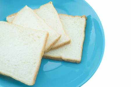 Slice of bread on blue plate with white background