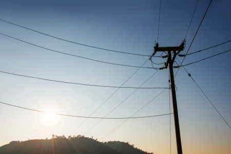 electrical post by the road with power line cablesの写真素材