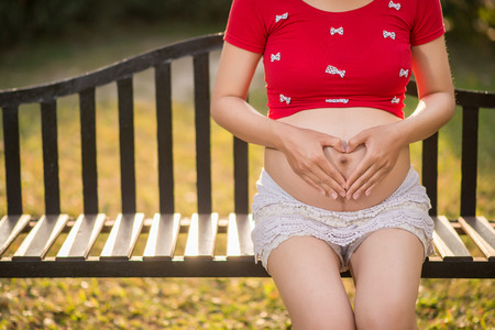 Image of pregnant woman touching her belly with handsの写真素材