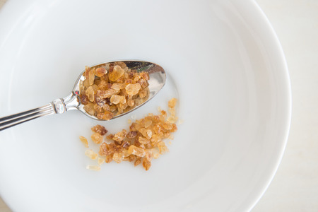 Crystalline Sugar and silver spoon (Brown Sugar)の写真素材