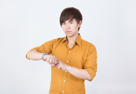 Handsame  man in orange shirt waitingの写真素材
