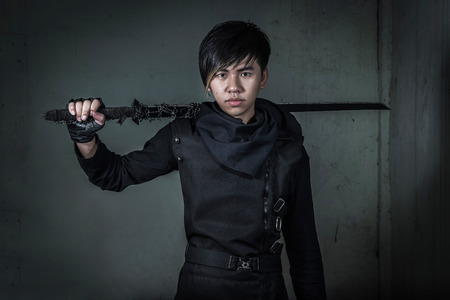 Asian man dresses as Ninja holding swordの写真素材