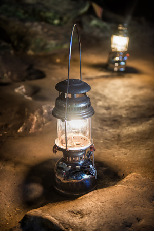 The old antique storm lantern in a caveの写真素材