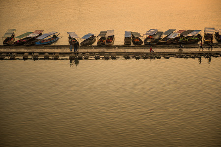 Sangkhla Buri, Thailand-Feb 14: Local people and tourists on the longest wooden bridge in western region of Thailand on February 14, 2015 in Sangkhla Buri, Thailand.のeditorial素材