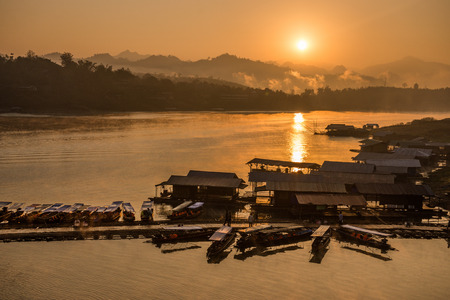 Sangkhla Buri, Thailand-Feb 14: Local people and tourists on the longest wooden bridge in western region of Thailand on February 14, 2015 in Sangkhla Buri, Thailand.のeditorial素材