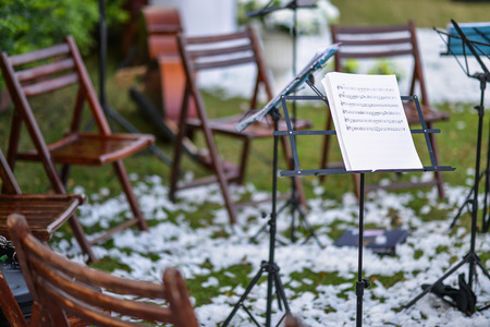 Music stand and empty chairs in the gardenのeditorial素材