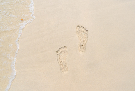 sand beach as footprint shapeの写真素材