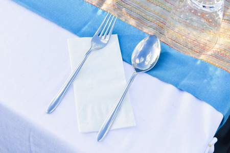 Table setting for meal with spoon, folk, and napkins