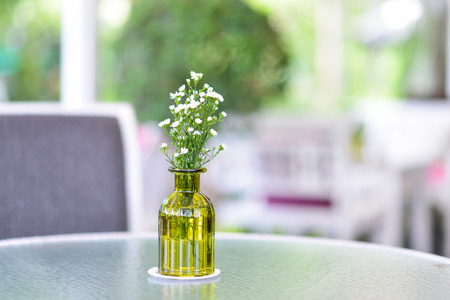 White Flower in glass vase on glass tableの写真素材