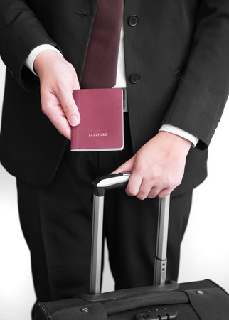 Hand holding Thai passport, ready to travelの写真素材