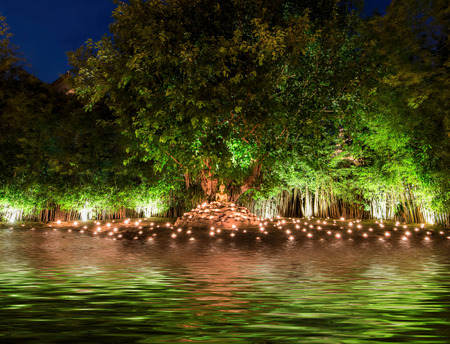 Buddha Image among the candle and water, Thailandの写真素材