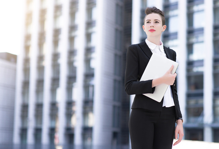 Modern business woman holding laptopの写真素材