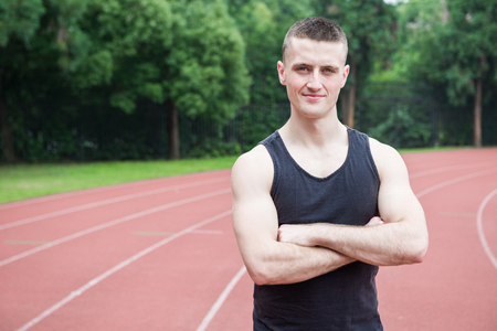 Handsome athlete man at running track