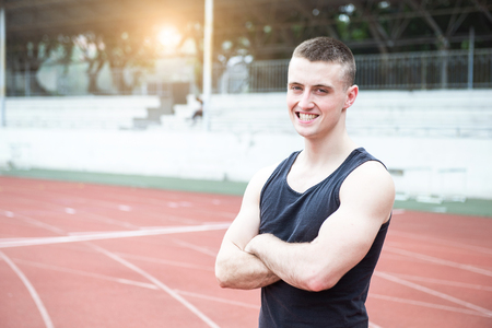Handsome athlete man at running trackの写真素材