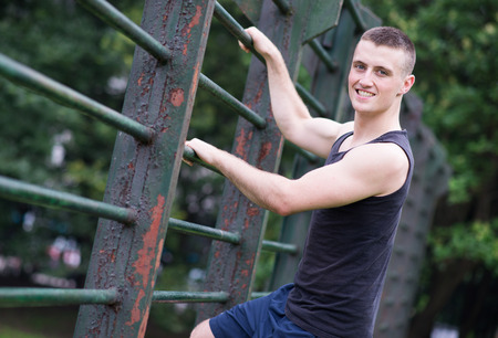 athlete man climbing a bar