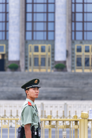 BEIJING, CHINA - JUNE 27, 2016: Chinese soldier marching in Tiananmen square with the Chinese...