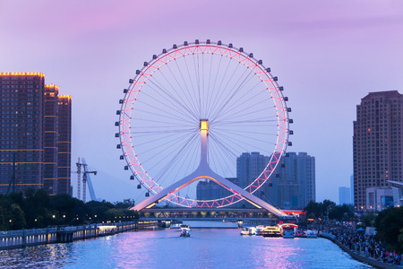 TIANJIN, CHINA - JUL 04, 2016: Tianjin is a metropolis in northern coastal China, tall giant Ferris wheel built above the Yongle Bridge, over the Hai River in Tianjin. JULY 04, 2016のeditorial素材