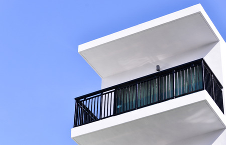 Modern apartment balcony against blue skyの写真素材