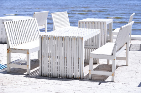 Tables and chairs near the sea