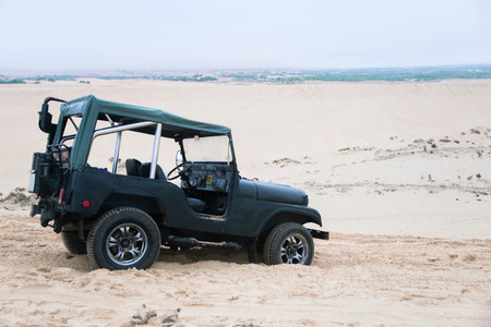 car with white sands. Vietnam desert,Popular tourist attractions in South of Vietnam.