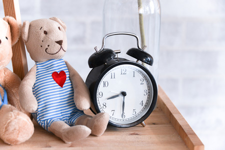 Retro alarm clock and dollsの写真素材