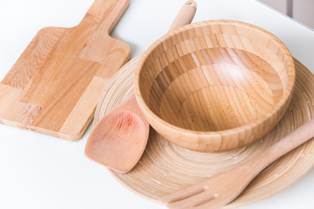 Handmade wooden, vintage kitchen utensils on white table