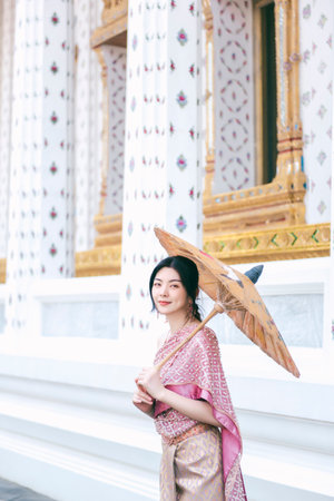 Beautiful Asian girl in Thai traditional costume at templeの写真素材