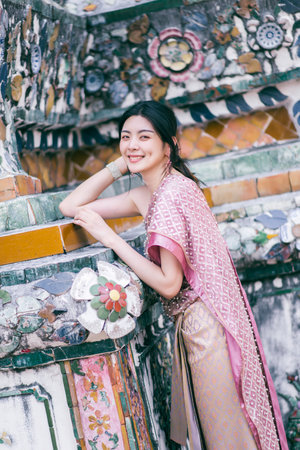 Beautiful Asian girl in Thai traditional costume at templeの写真素材