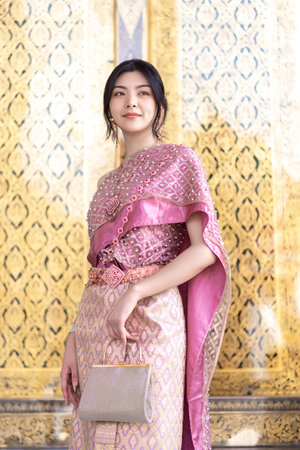 Beautiful Asian girl in Thai traditional costume at templeの写真素材