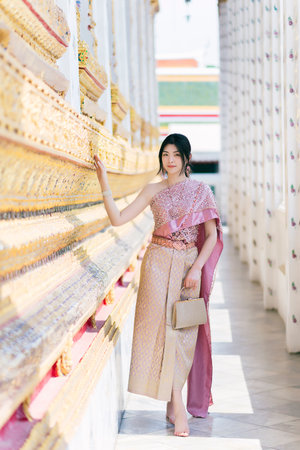 Beautiful Asian girl in Thai traditional costume at templeの写真素材