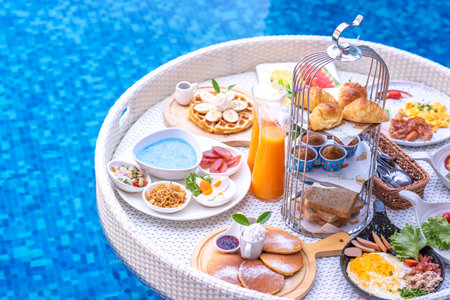 Breakfast in swimming pool, floating breakfast in villa resort. relaxing in calm pool water, healthy breakfast and tropical fruit.の写真素材
