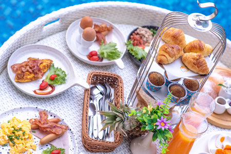 Breakfast in swimming pool, floating breakfast in villa resort. relaxing in calm pool water, healthy breakfast and tropical fruit.の写真素材