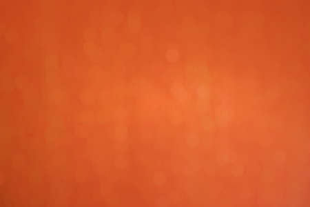 Bokeh of orange glitter diamond texture abstract background. Festive theme, sparkle backdrop, warm tone color, shiny element concept.の写真素材