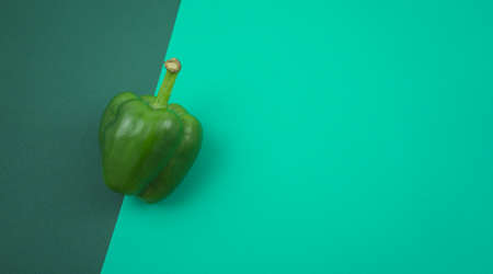 Fresh green sweet or bell pepper flat lay on turquoise green texture background. Free space for your design, top view, horizontal, no people image style.の写真素材