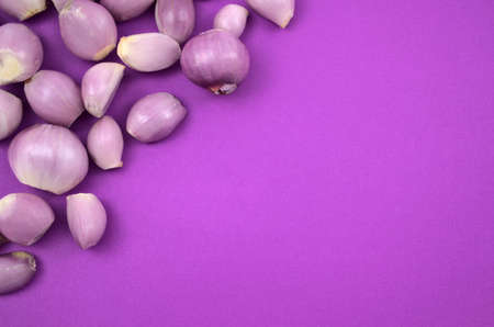 Fresh peeling onions flat lay on purple background. Copy space for text or design, top view, horizontal image style.の写真素材