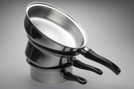 Clean and shiny stainless steel pots and pans.の写真素材