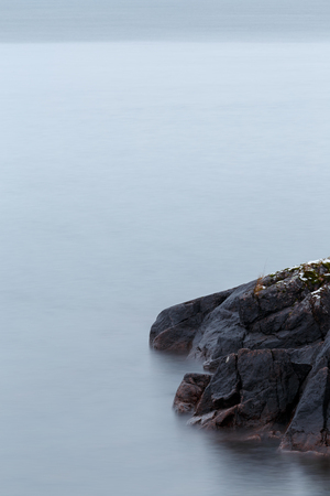 Rocks in foreground at lakeの写真素材