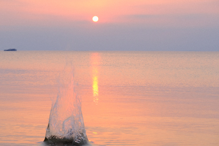 A big splash in the lake at sunsetの写真素材