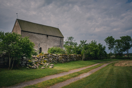Old church and broken stone wallの写真素材