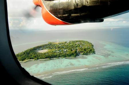 View through sea plane propeller over a maldivian islandの写真素材