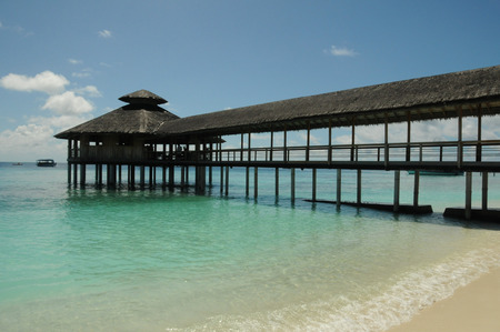 Wooden Pier leading out into the ocean, floating restaurantの写真素材