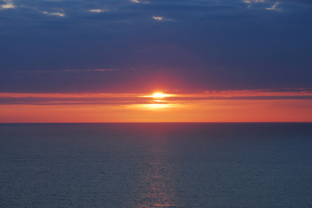Beautiful Red and Blue Sunset or Sunrise horizon over the Oceanの写真素材