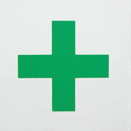 green emergency cross on white backgroundの写真素材