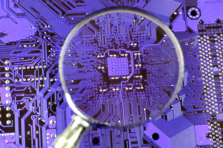 Printed circuit board seen by magnifying glassの写真素材