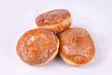 Three donuts with filling and poured with the sugarの写真素材