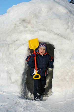 Boy stands in door of iglo