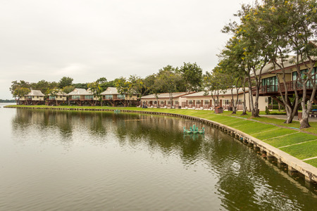 Tree houses and bungalows in the resort in front of poolの写真素材