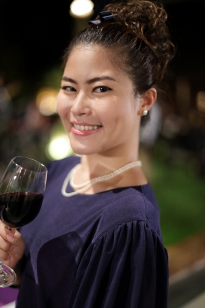 Asian Girl Holding Wineの写真素材
