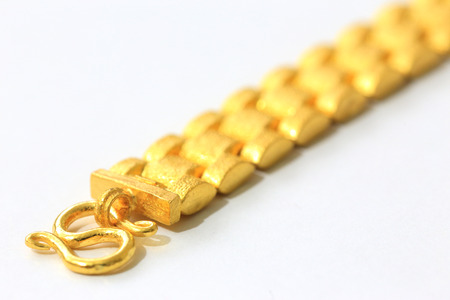 Shiny Gold Bracelets and Necklace on White Backgroundの写真素材
